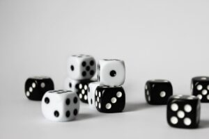 A set of black and white D6 dice stacked on a table.