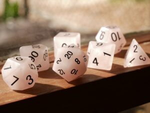 Set of gaming dice and D20 on a table.