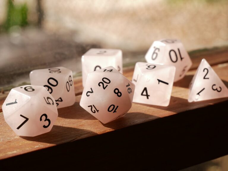 Set of gaming dice and D20 on a table.