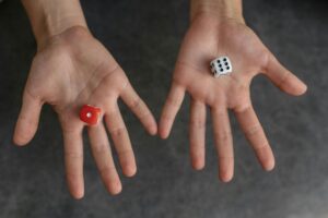 Two open hands with a D6 Dice in each.
