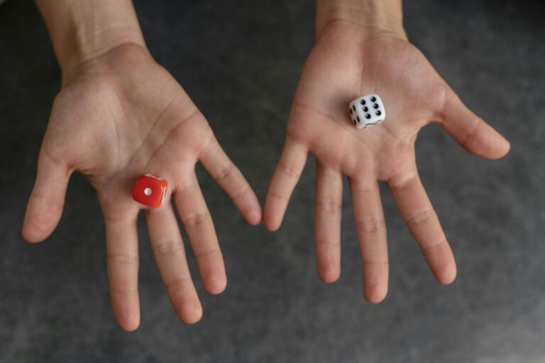 Two open hands with a D6 Dice in each.